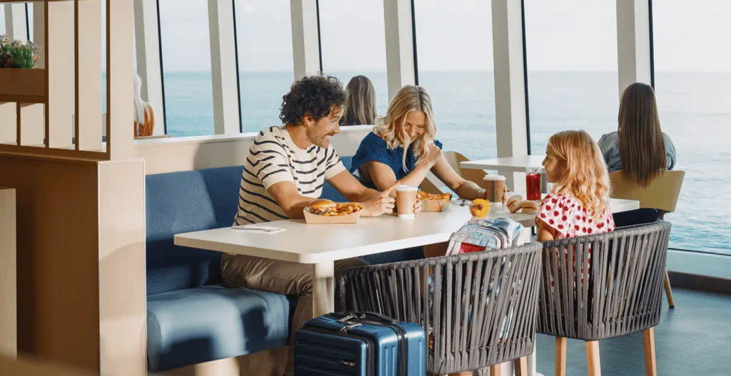 Tavolo apparecchiato in un ristorante di traghetto moderno con ampie vetrate panoramiche sul mare aperto