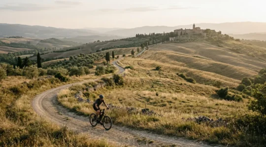 Ciclista su e-bike che esplora un sentiero panoramico tra colline verdi e borghi remoti